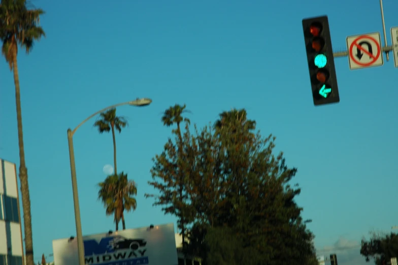 traffic lights and signs on the street under blue sky
