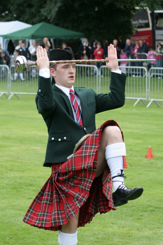 a man dressed in a scottish costume playing bagpipes