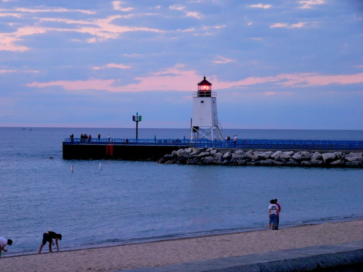 a view of the lighthouse and ocean with s at sunset