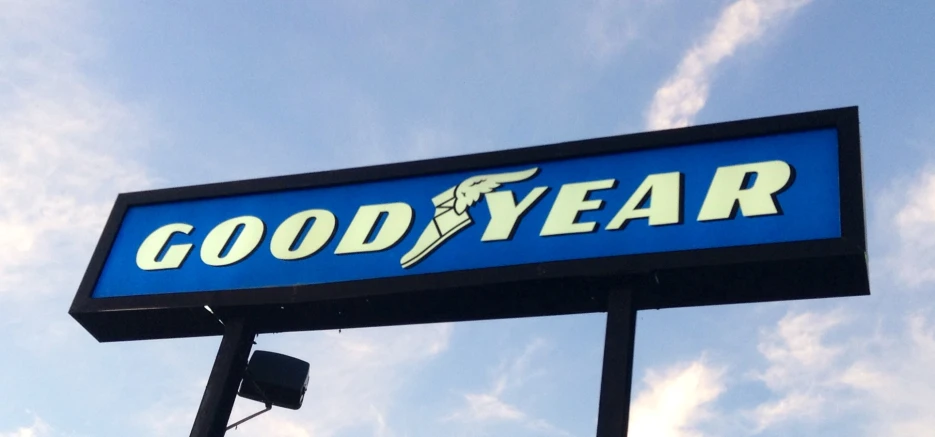 a sign advertising a goodyear restaurant against a blue sky
