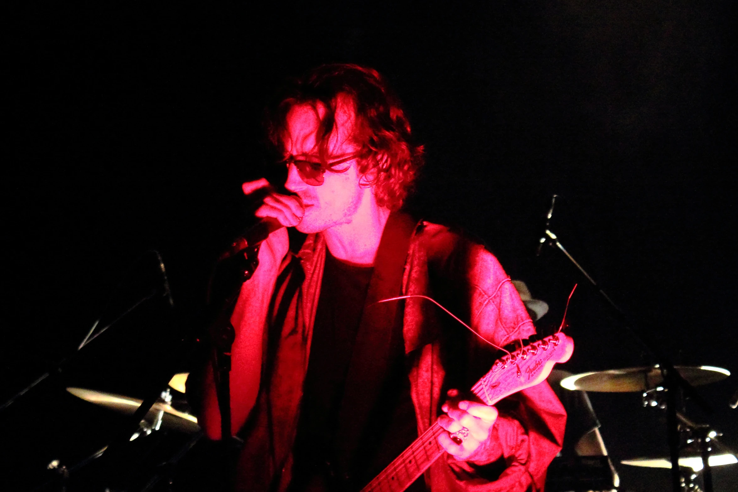 a musician is seen in the dark during his live concert