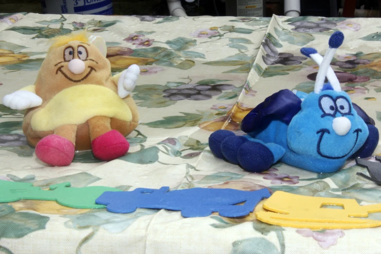 a stuffed animal and other toys are on a table