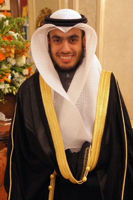 a man in a costume standing and smiling for the camera