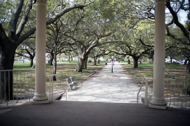 two benches are at the end of an arched walkway