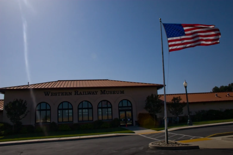 the flag flying high in the sky outside a military museum