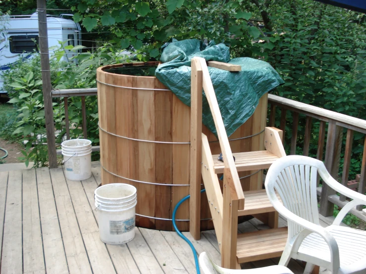 a  tub is on a porch near some chairs