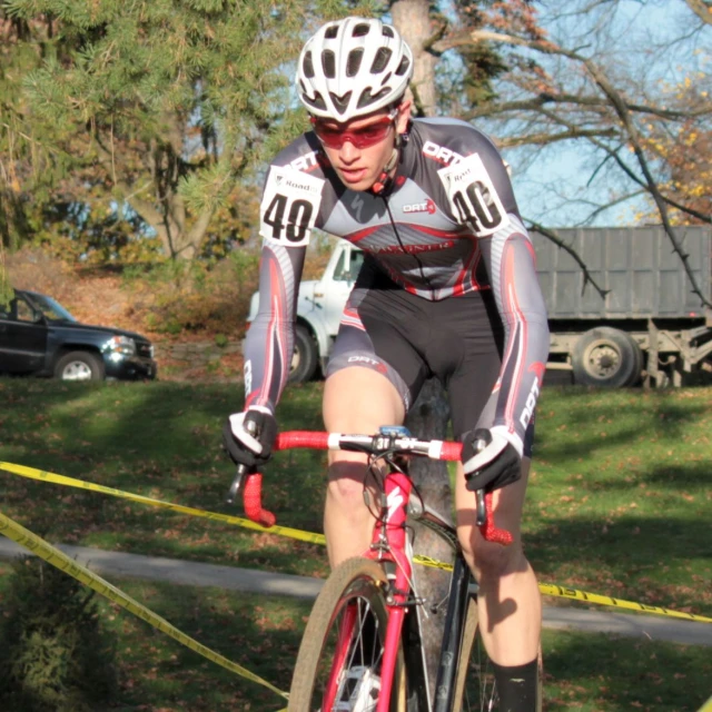 cyclist in red bicycle suit going around the course