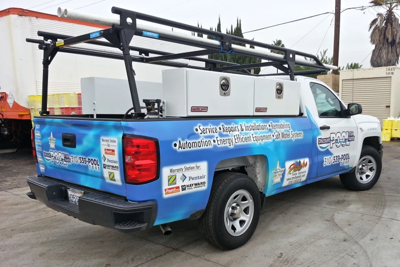 a truck parked on the side of the road with a large water heater on top of it