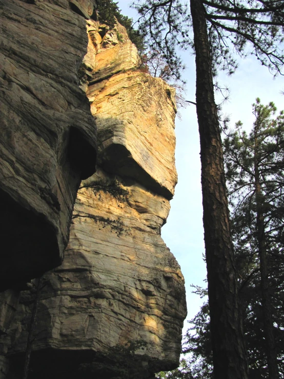 the side of the mountain has several small holes in it