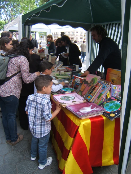 children looking at book sale for children