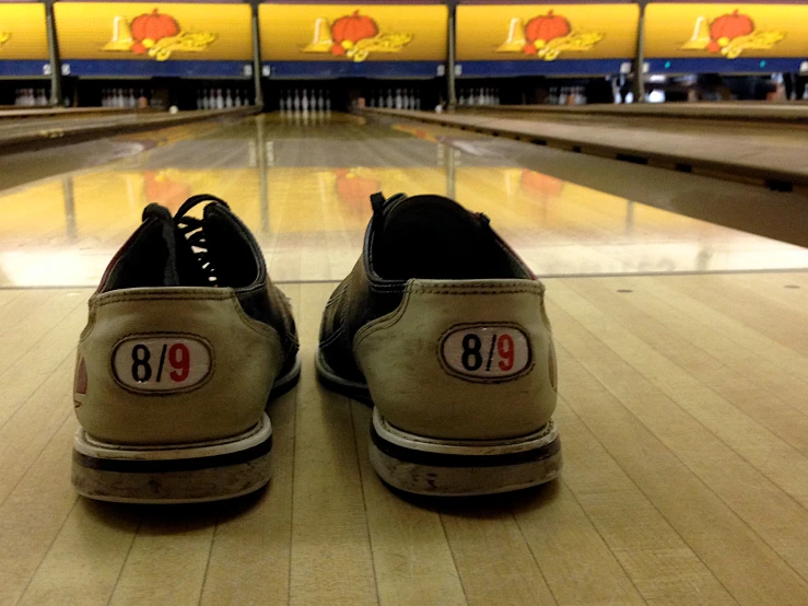 a person with sneakers in the background at the bowling alley