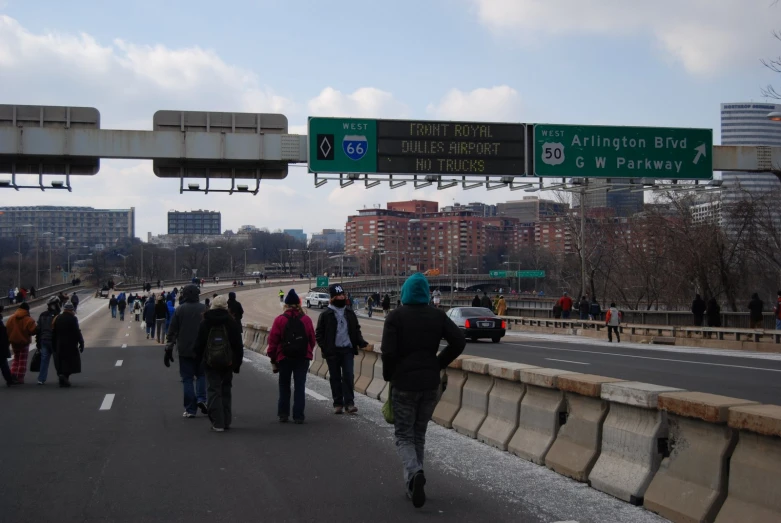 a large group of people walking down the street