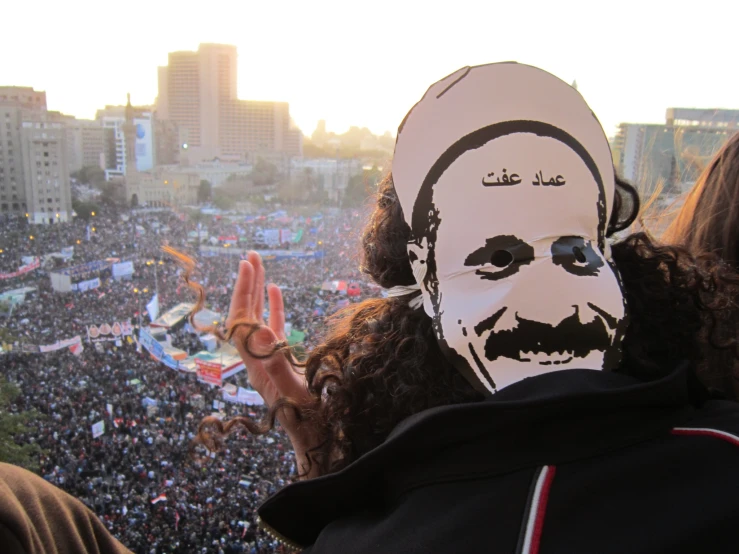 people are seen wearing a face mask as they gather