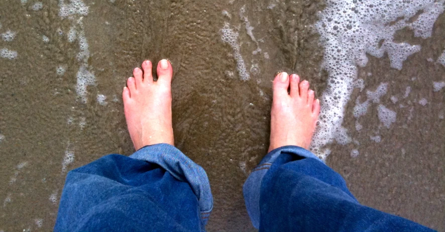 the view of someone's feet on the beach