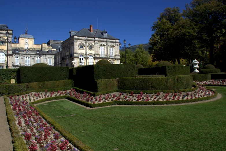 a house with hedges and a garden in front