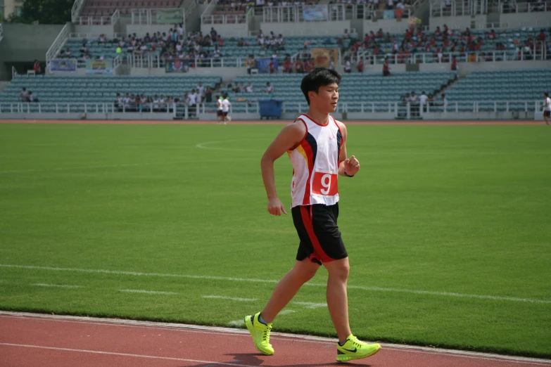 a man in sports clothes walking across a track