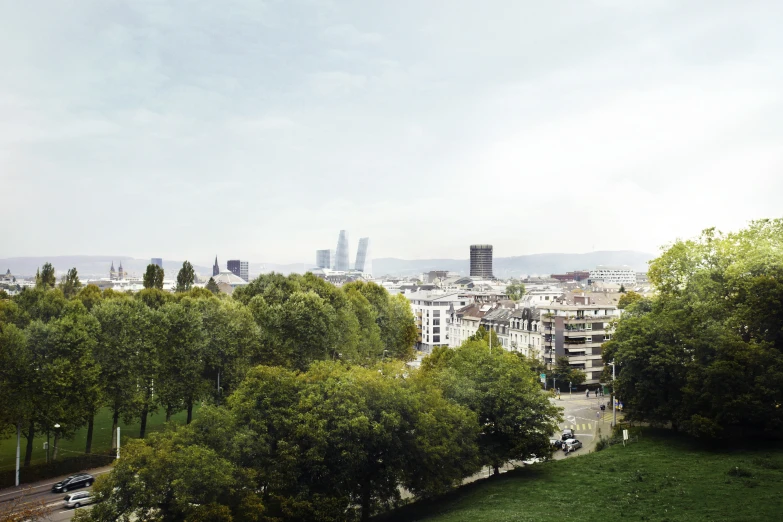 the view from atop of a hill of trees and tall buildings in the background