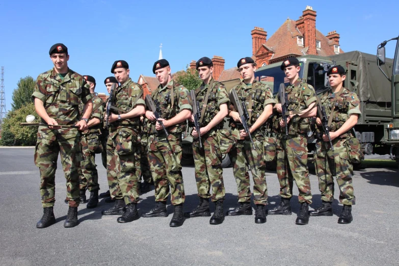 several military men in uniforms holding guns