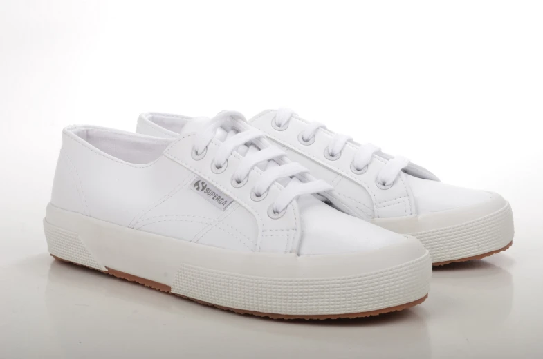 a white sneaker shoe is on a white surface