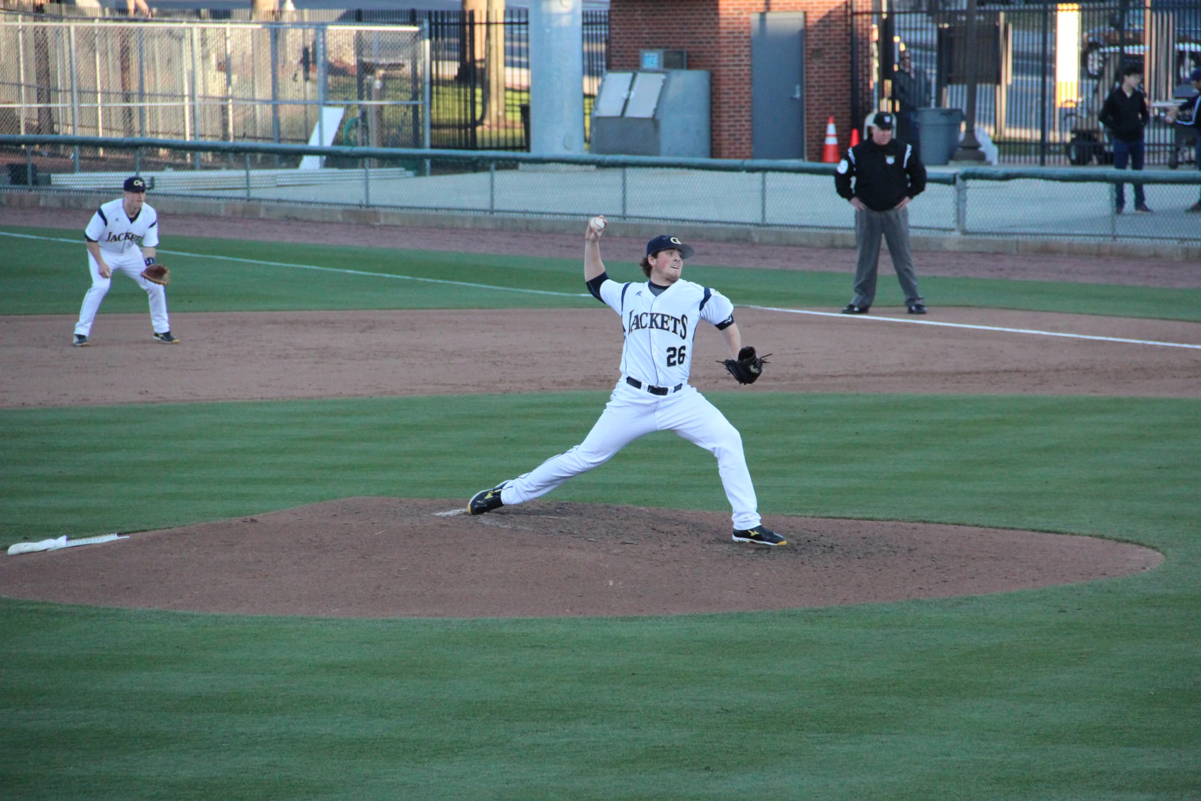 a baseball pitcher on the mound at a game