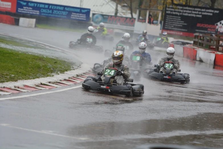 racers racing down the track on their go - karts