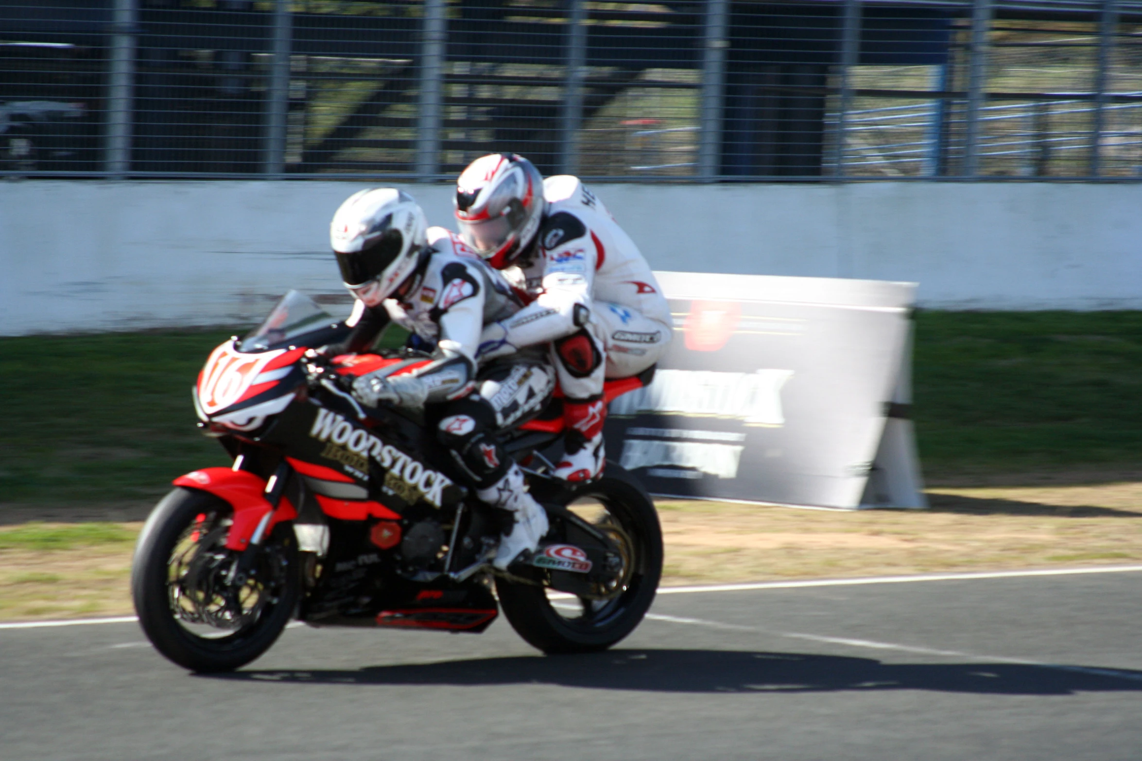 two riders are riding on their motorcycle at a speed