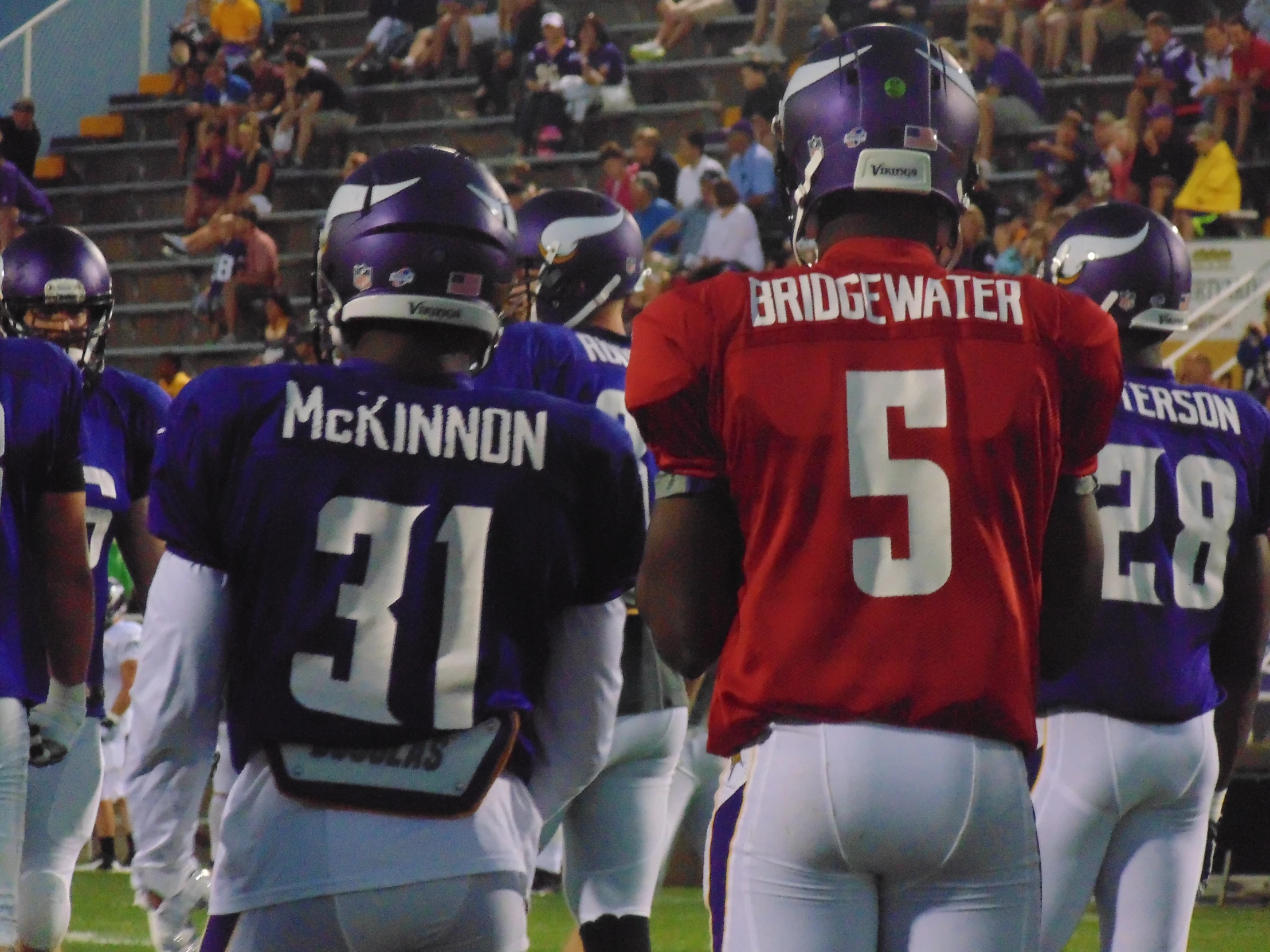 football players are standing with numbers on their uniforms