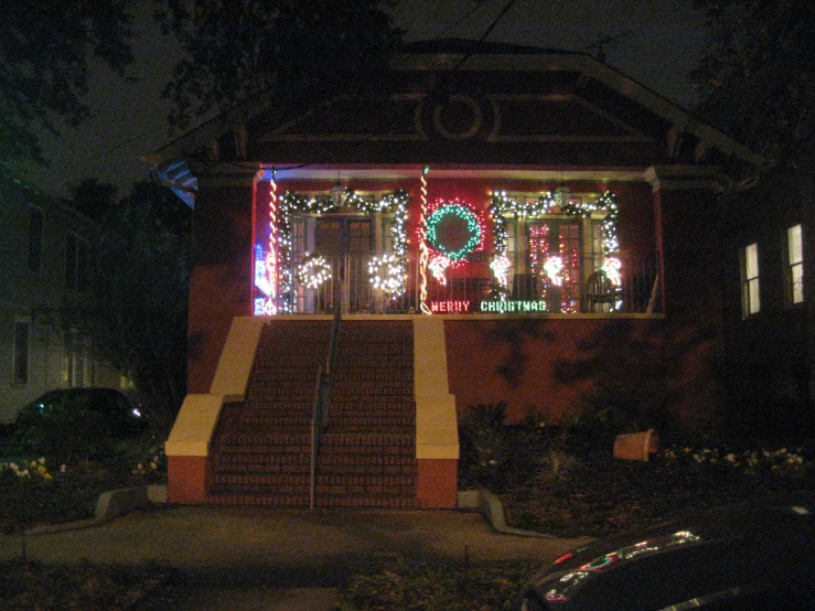 a big house decorated with christmas lights and wreaths