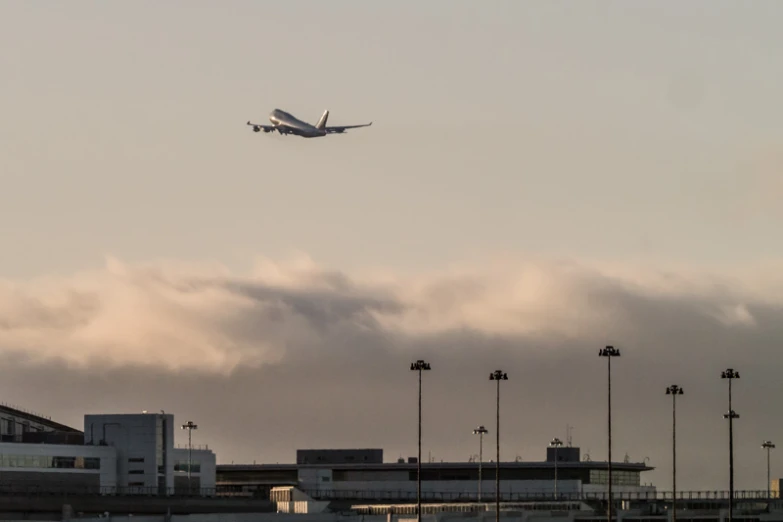 a large jetliner flying through a cloudy sky