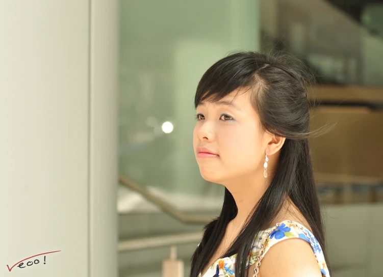 a woman that is standing in front of a light