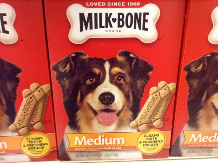 two packages of milk - bone biscuits with a dog's head inside