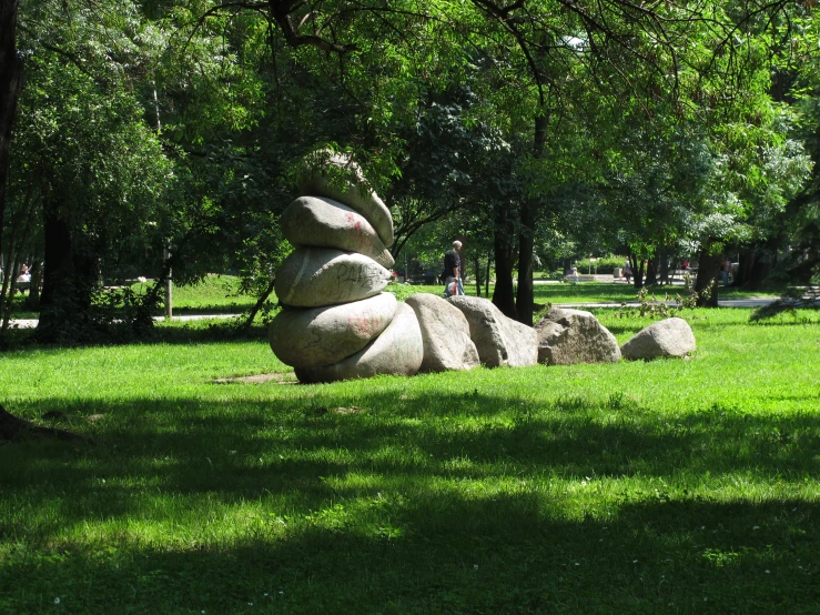 a pile of rocks sits in the middle of a park