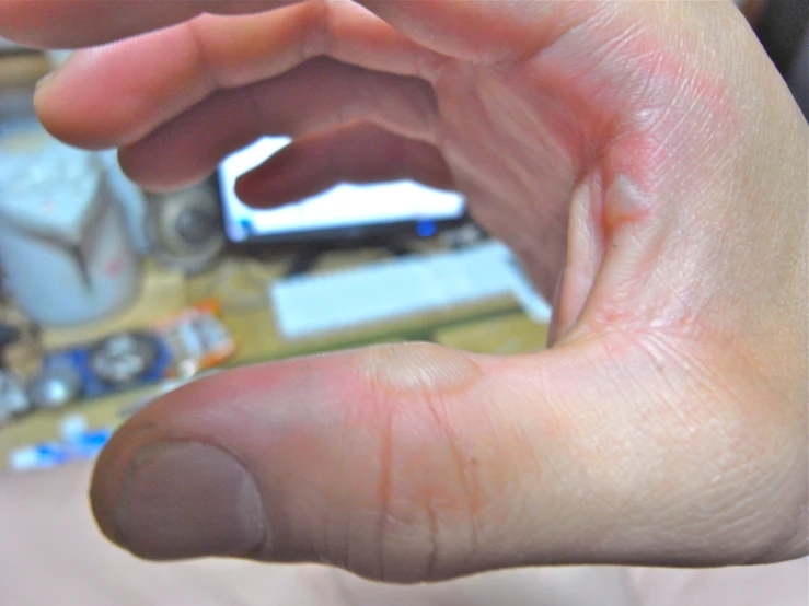 an adult hands are holding soing small with fingers