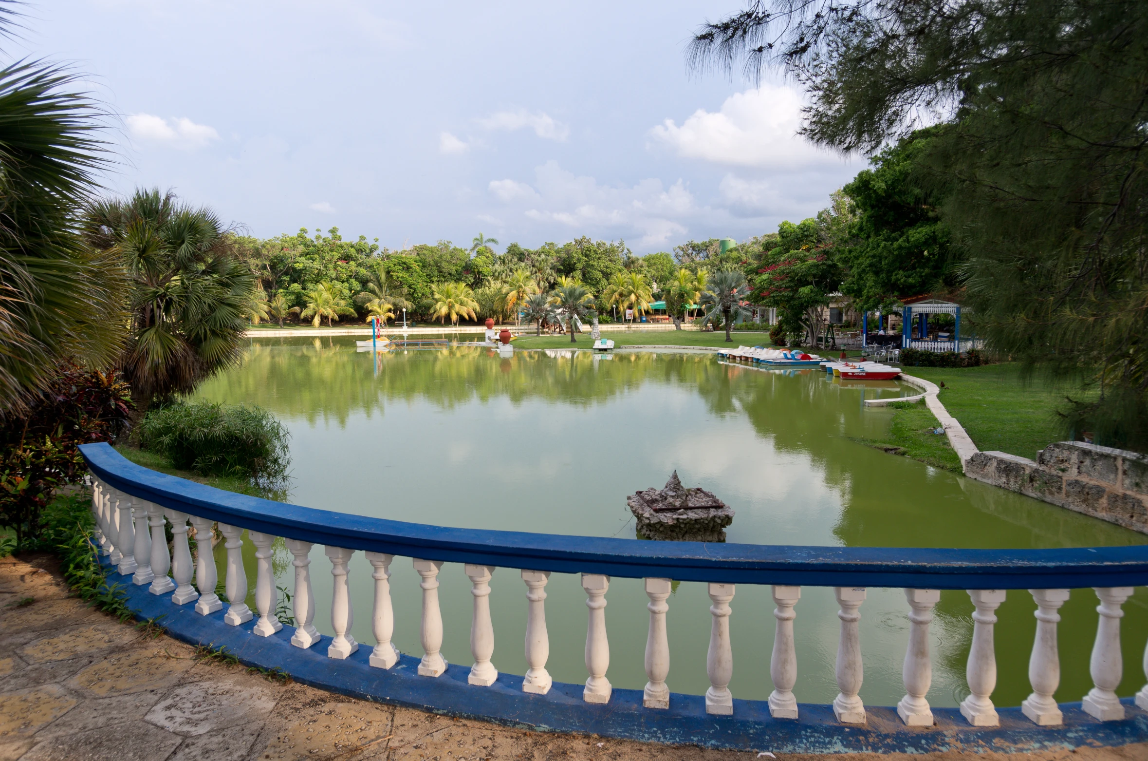 a blue and white fence sitting next to water