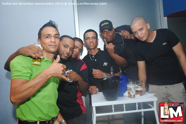 a group of people standing around a white table