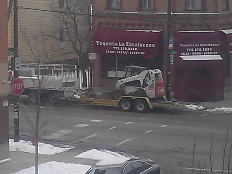 a tow truck that is towing a semi