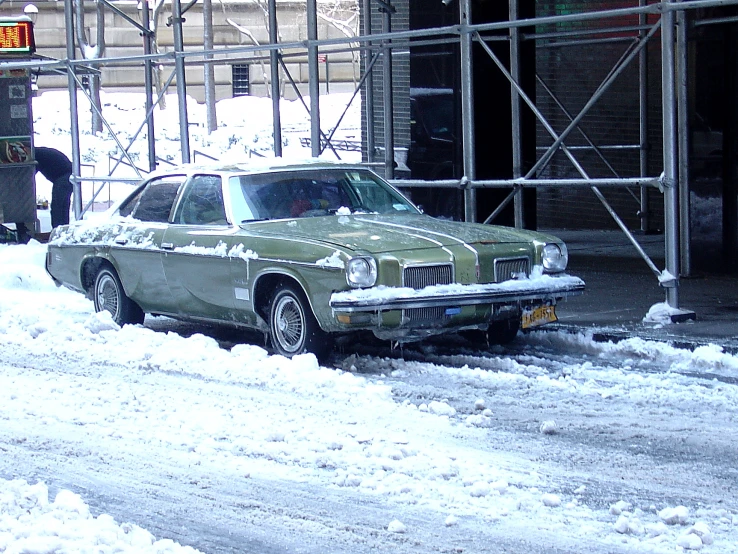 a car parked in front of a building under construction