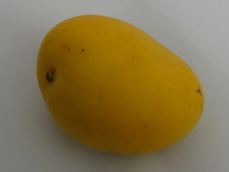 a fruit on a white surface with a light colored background