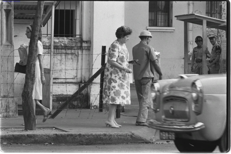 an old black and white po of a couple outside a building