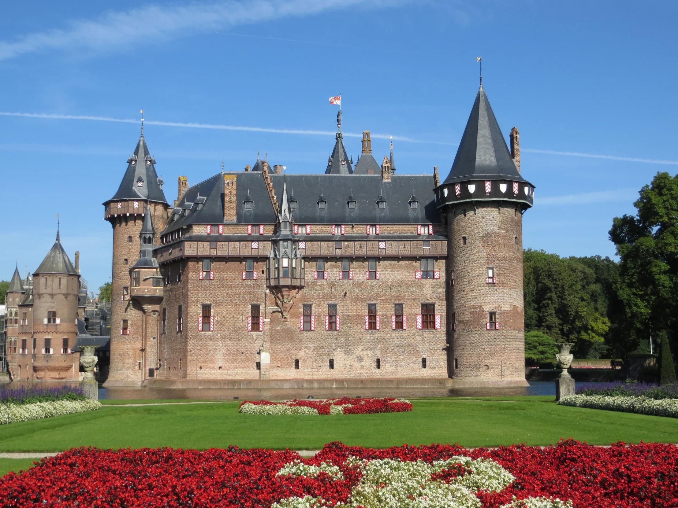castle type building with multiple turrets and red flowers