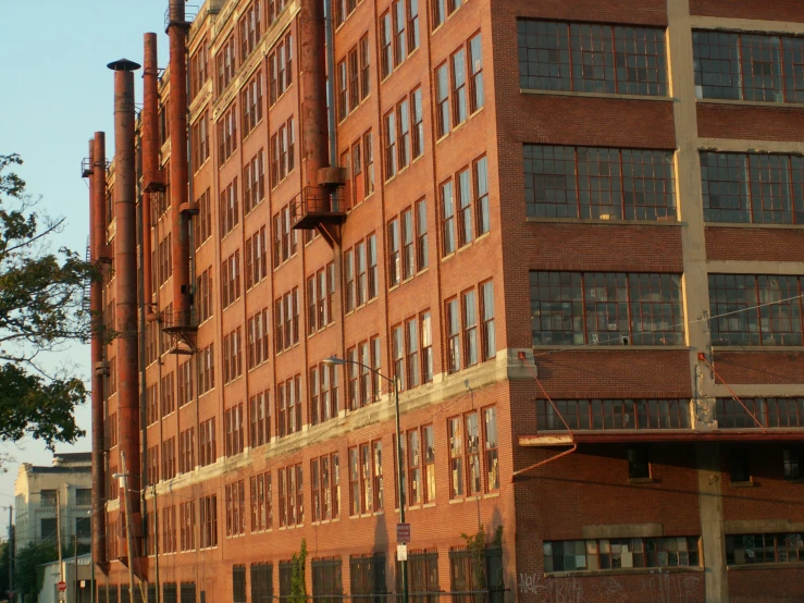 an old red brick building that is in the middle of a city