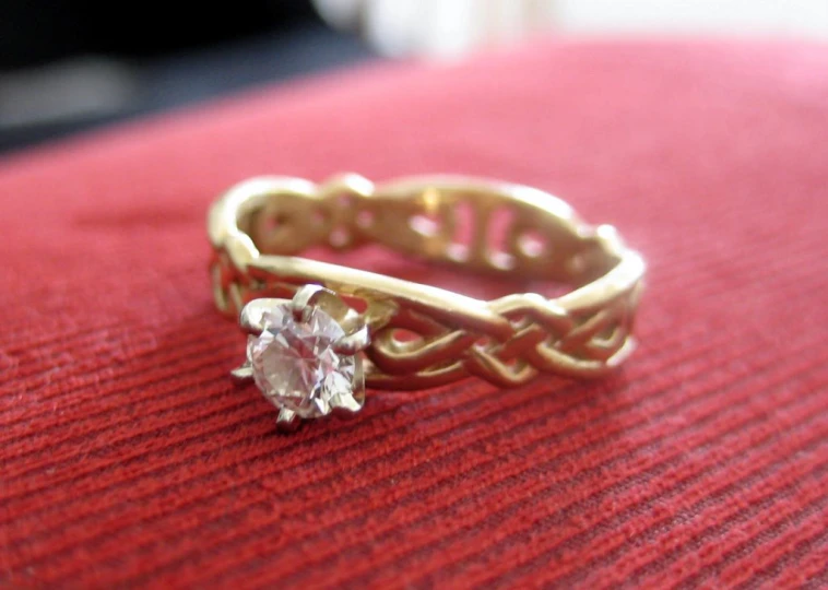 an old style ring with a pink cubic - stone on the middle of it