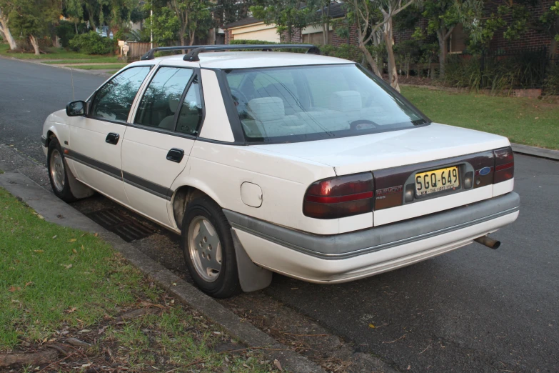 the car is parked on the side of the road