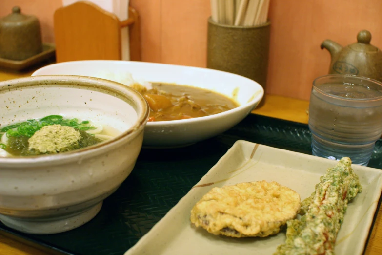 soup, sandwich, and bread is on a tray on a table