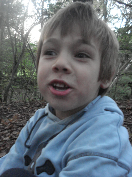 a close up of a child with a cell phone