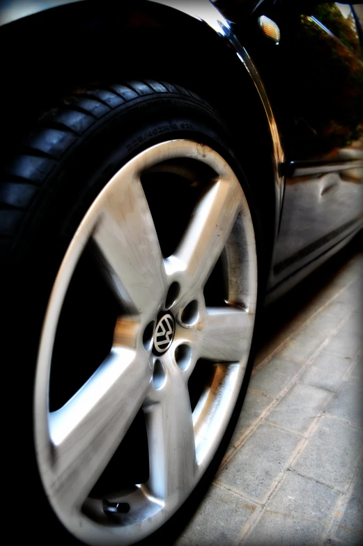 a black car is sitting on the street