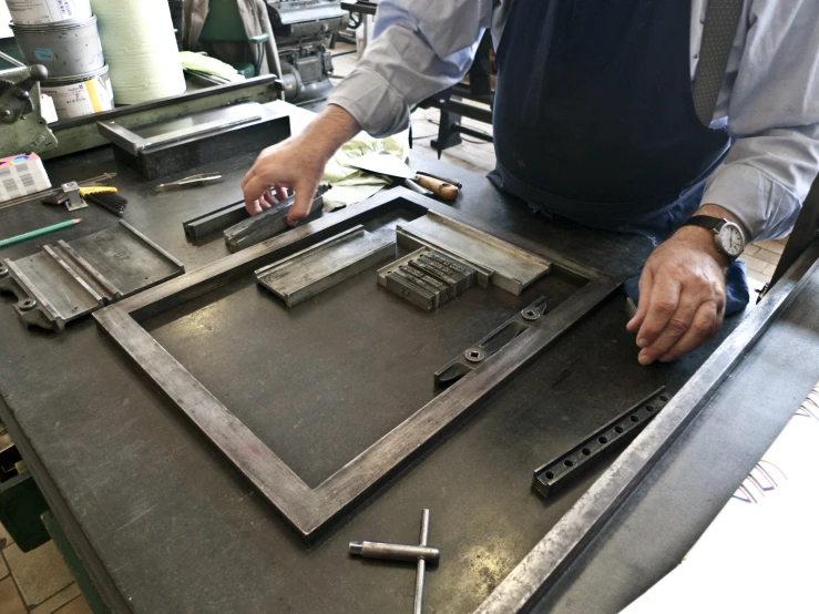 an image of a person making a frame for a painting