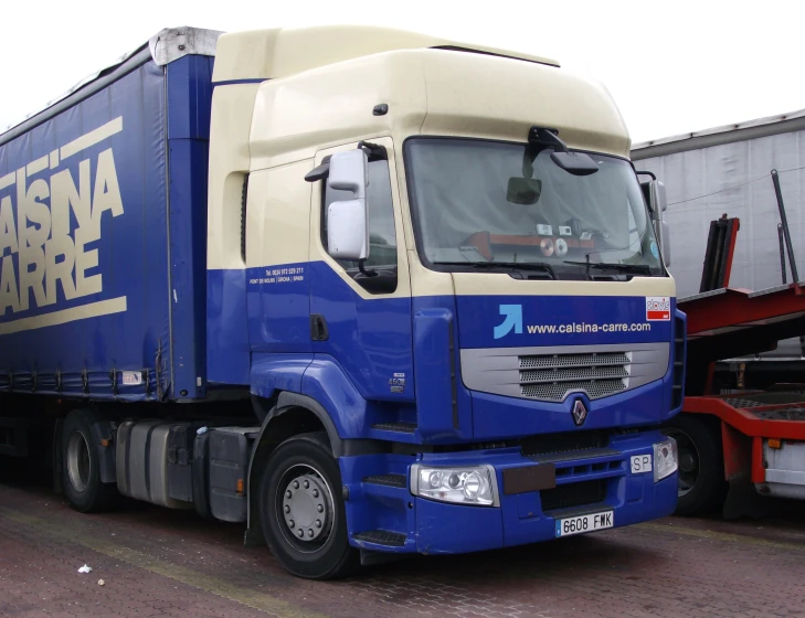 a blue truck parked in front of other cars