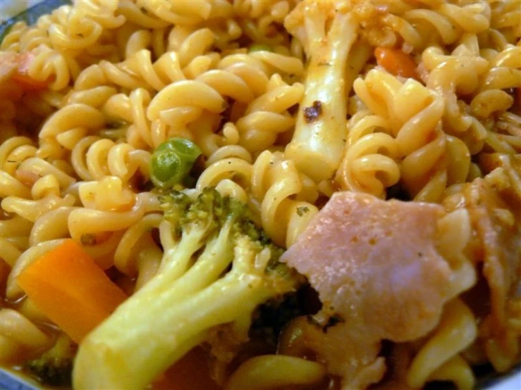 a plate filled with noodles and vegetables on a table