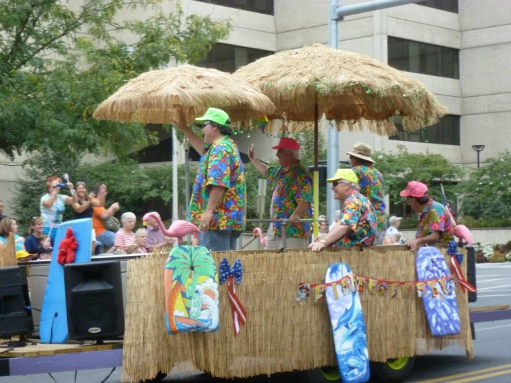 men in hawaiian outfits on top of a float